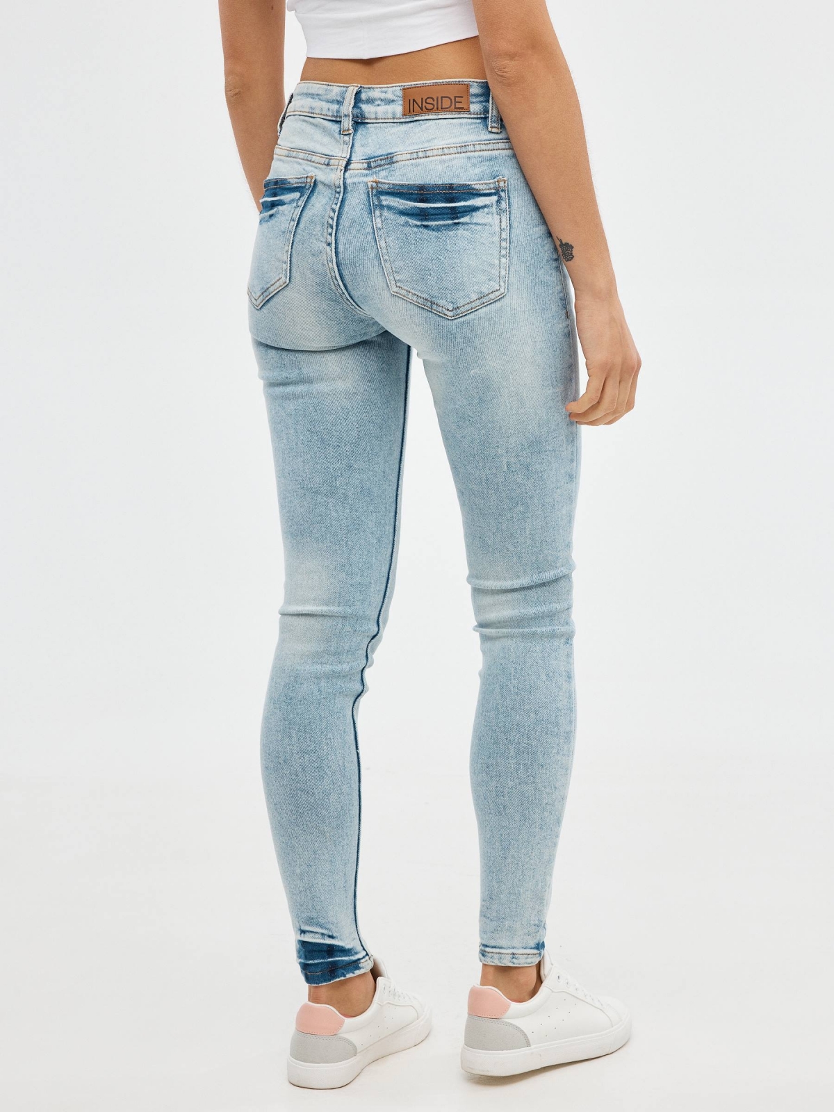 Light denim skinny jeans blue middle back view