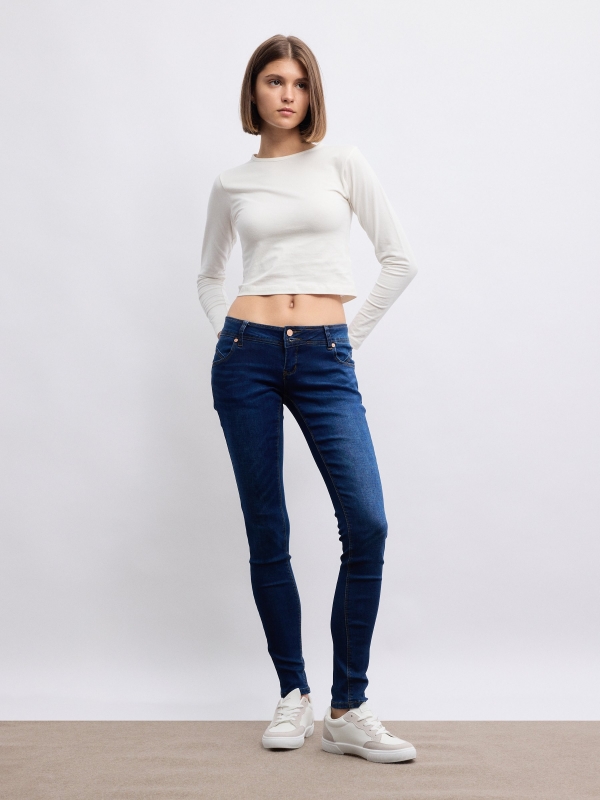 Low-rise distressed skinny jeans blue front view