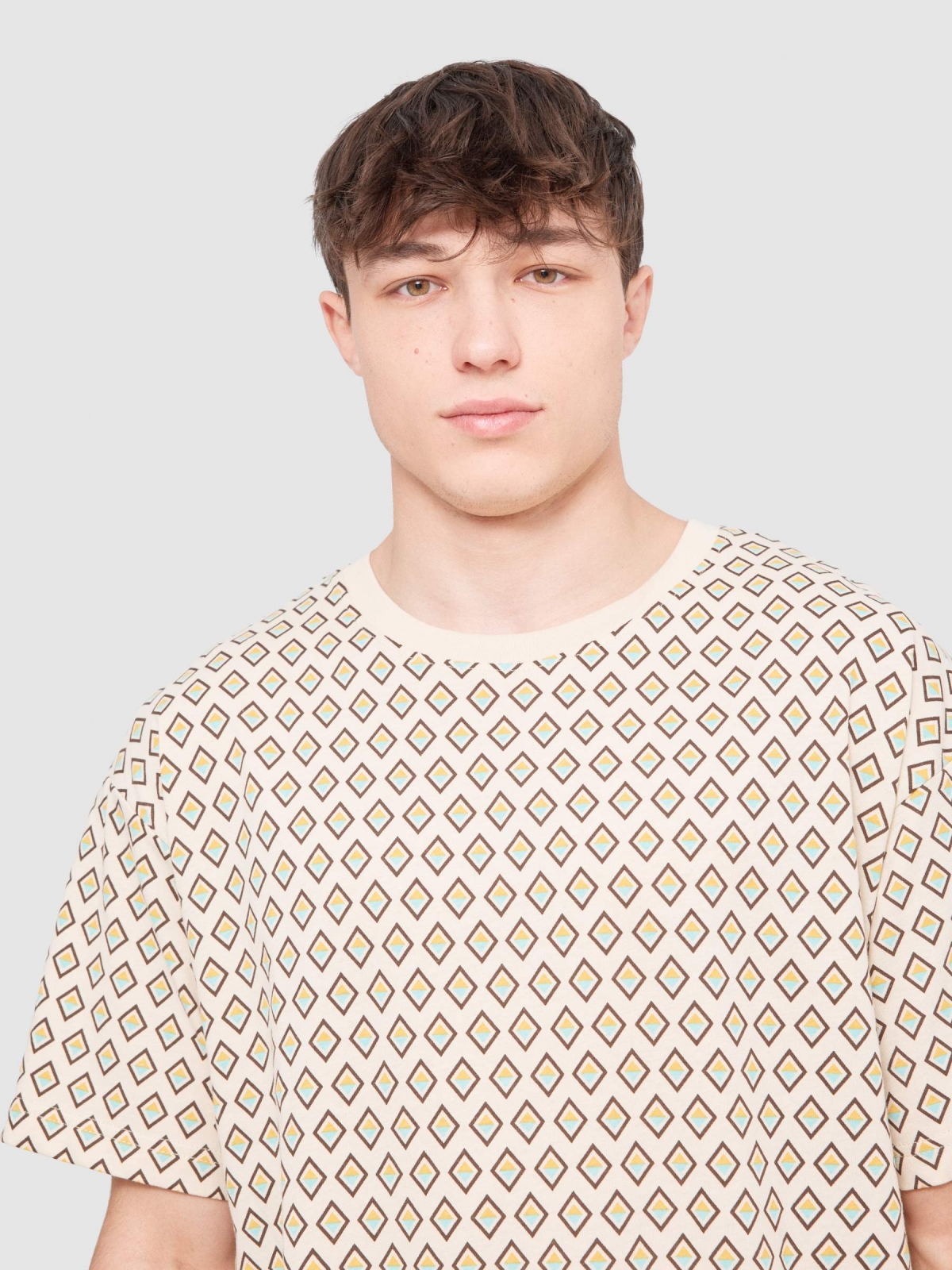 Geometric mosaic T-shirt sand detail view