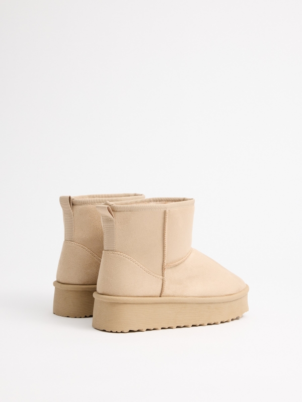 Platform ankle boots with beige fur lining sand 45º back view