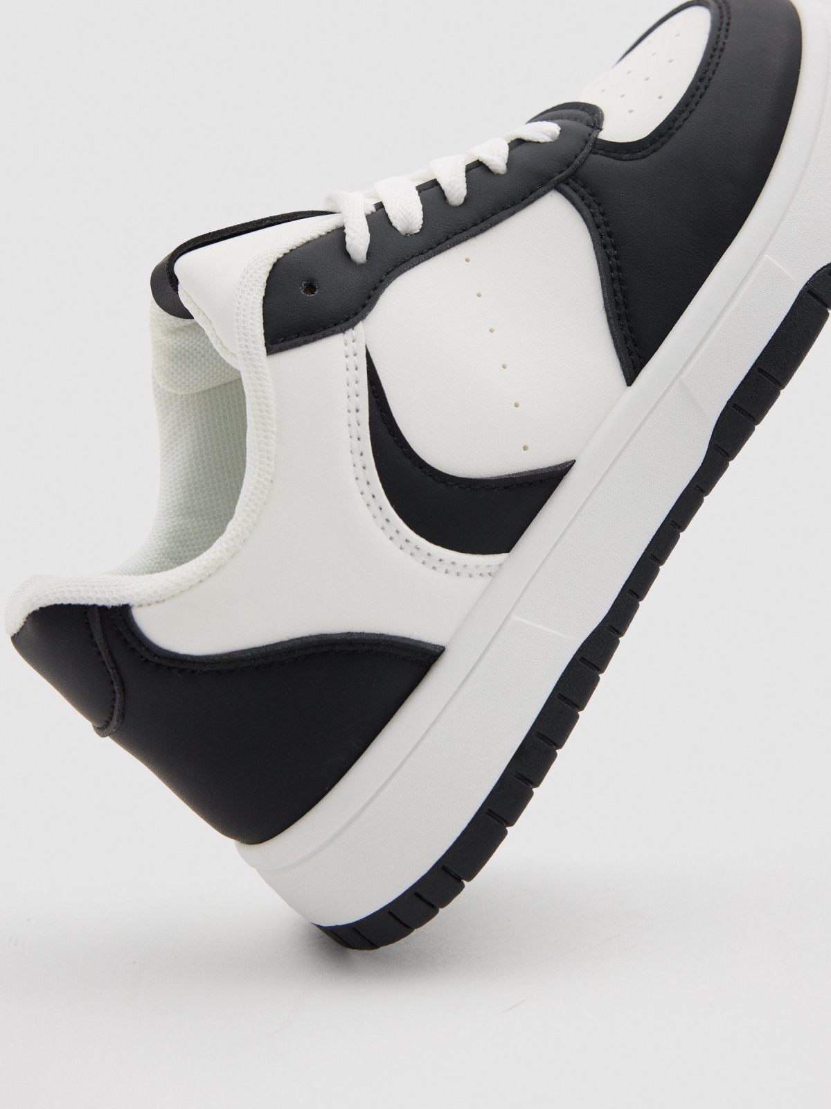 Casual sneakers combined with faux leather white detail view